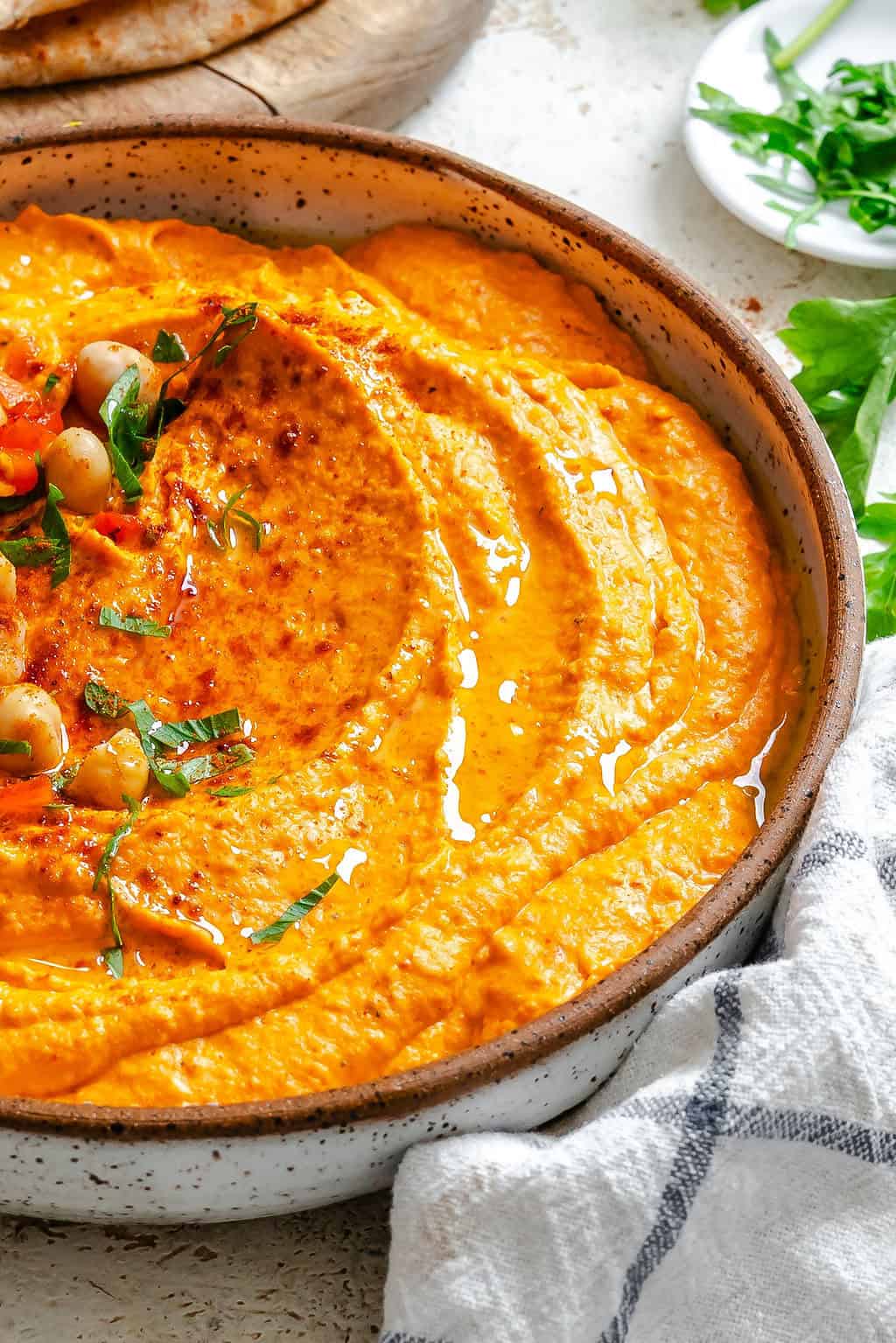 Roasted Red Pepper Hummus with chickpeas and parsley for garnish