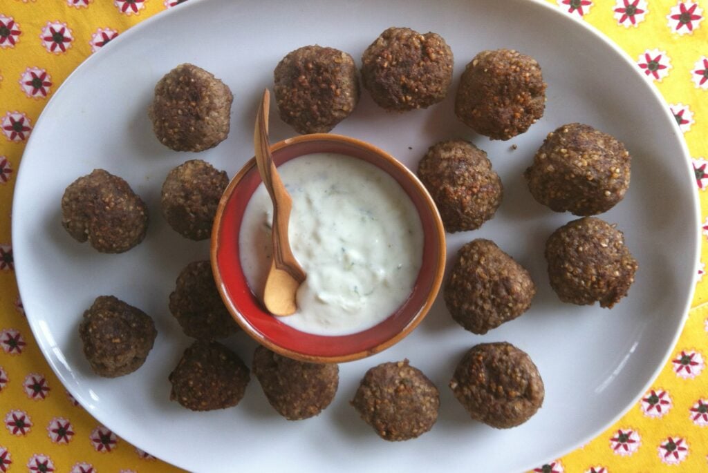 plate of Kibbeh Meatballs With Spiced Yogurt Sauce