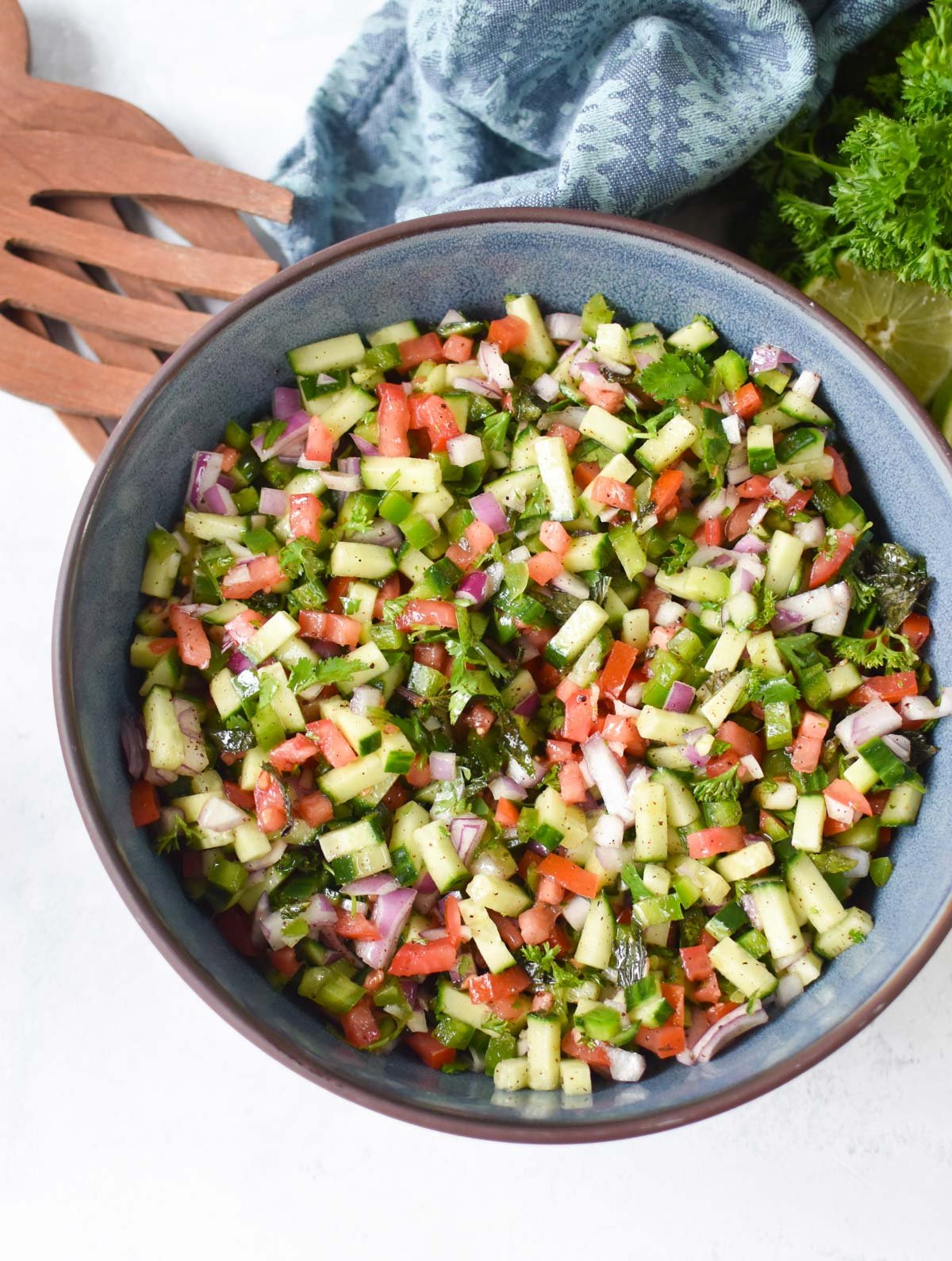 Shirazi Salad Recipe with wooden serving spoons 