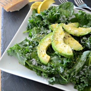 Avocado Kale Spinach Salad on white plate.