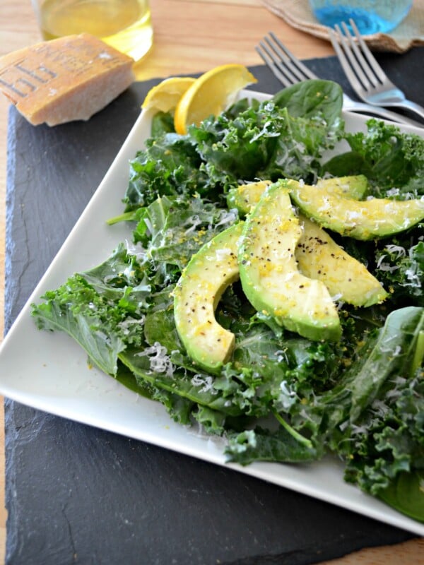 Avocado Kale Spinach Salad on white plate.
