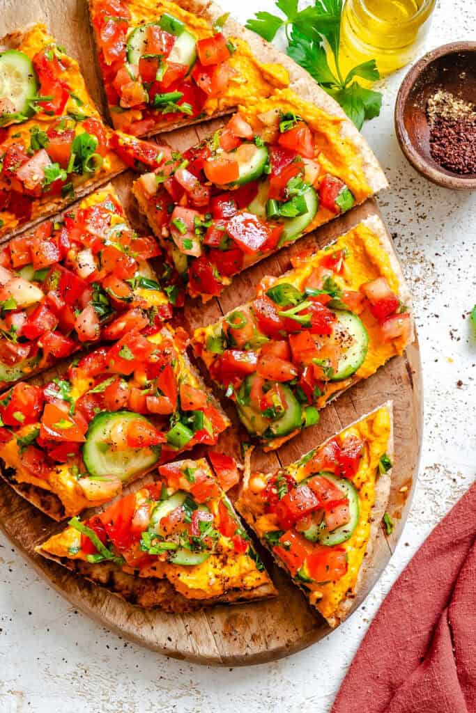 Mediterranean Naan Pizza on a wooden plate