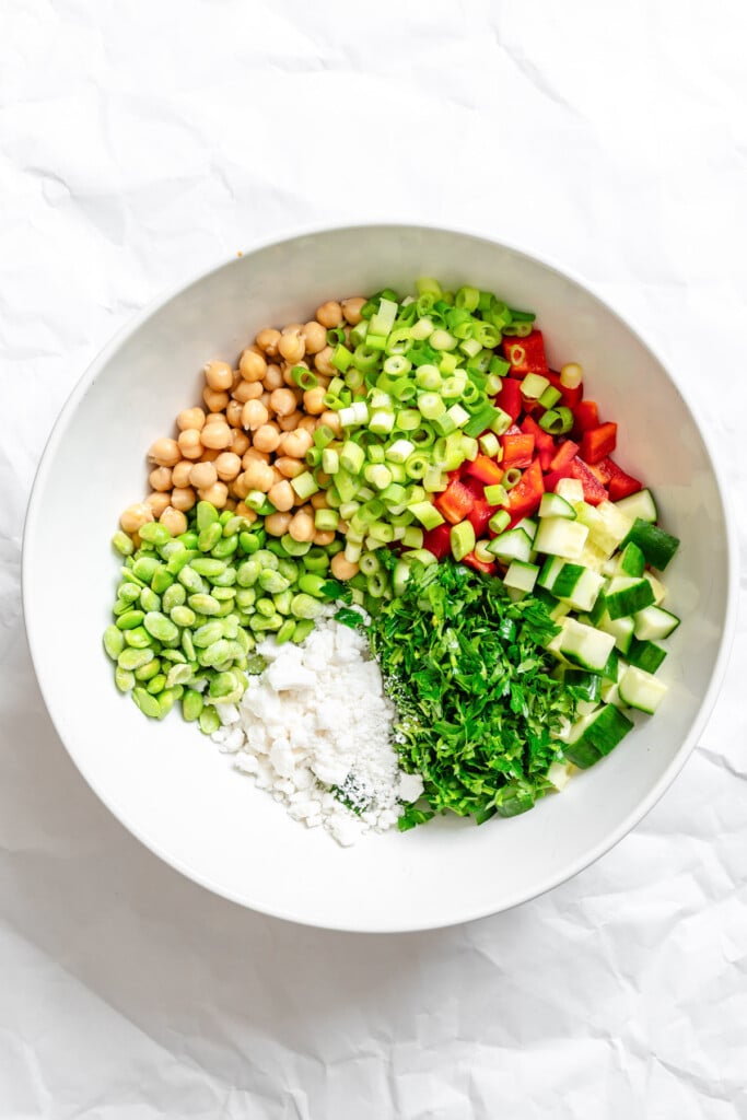 Edamame Chickpea Feta Salad ingredients in bowl