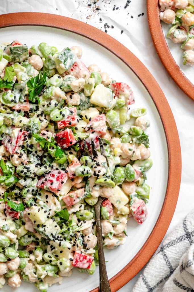 Edamame Chickpea Feta Salad on white plate with fork 