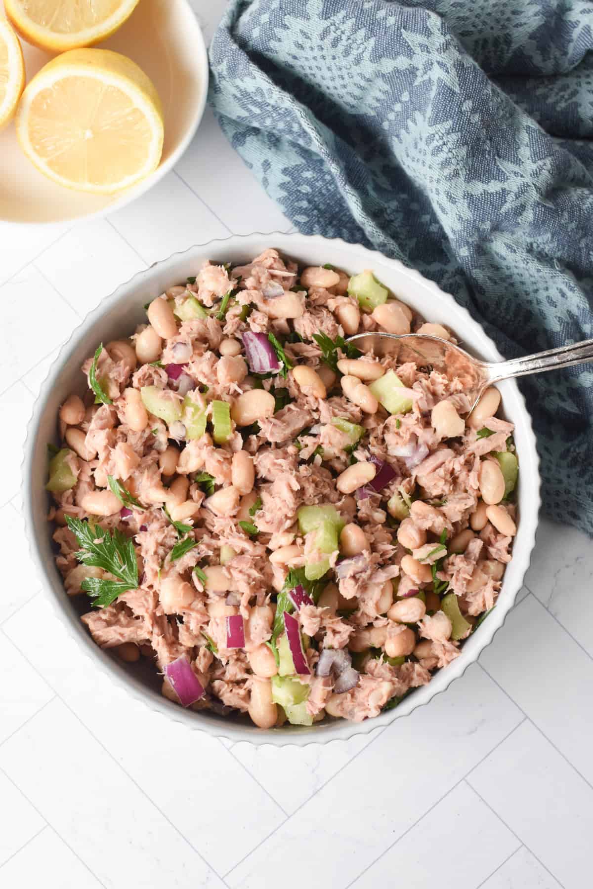 Tuna and White Bean Salad in a white bowl with a fork 
