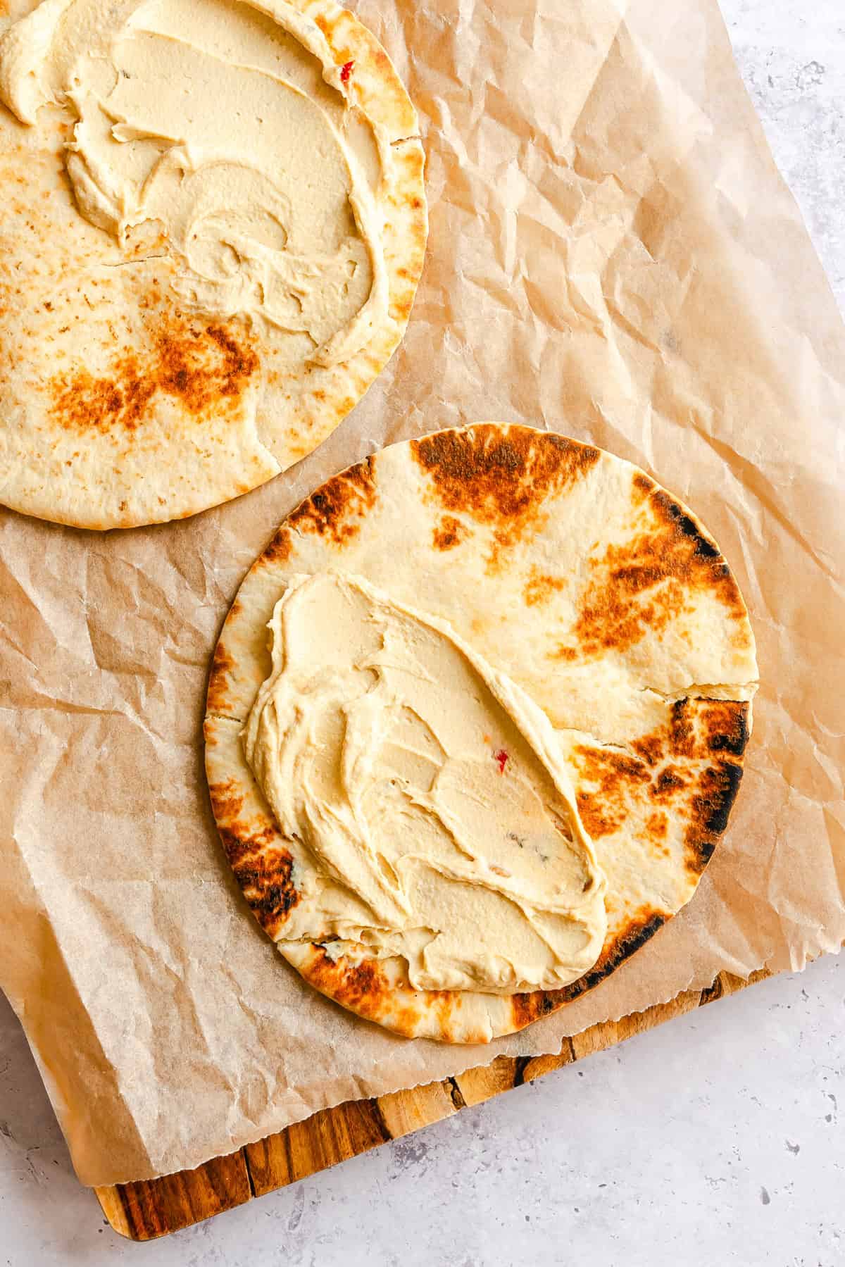 Hummus on pita on a cutting board