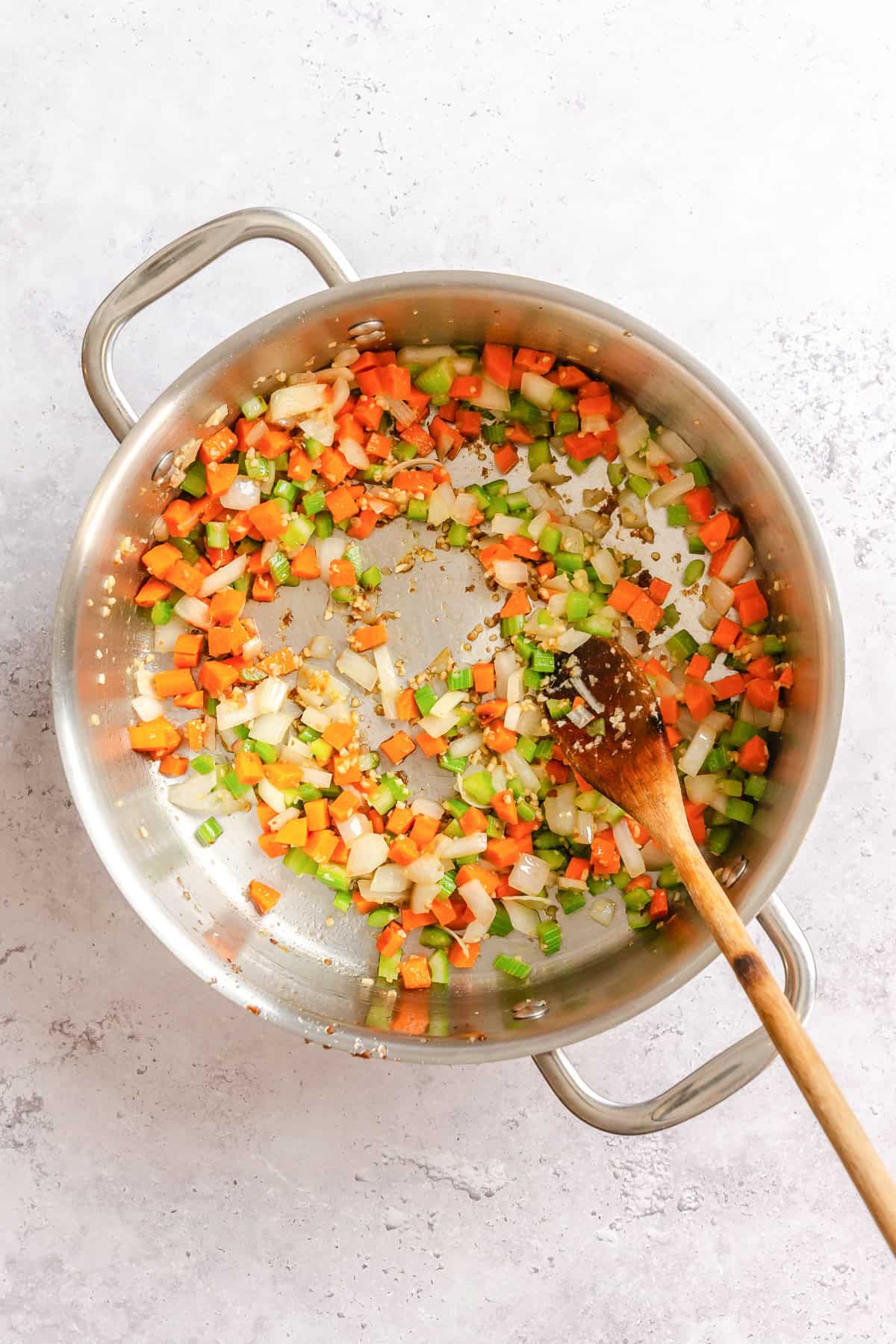 Vegetables sauteeing in a pot for pasta e fagioli