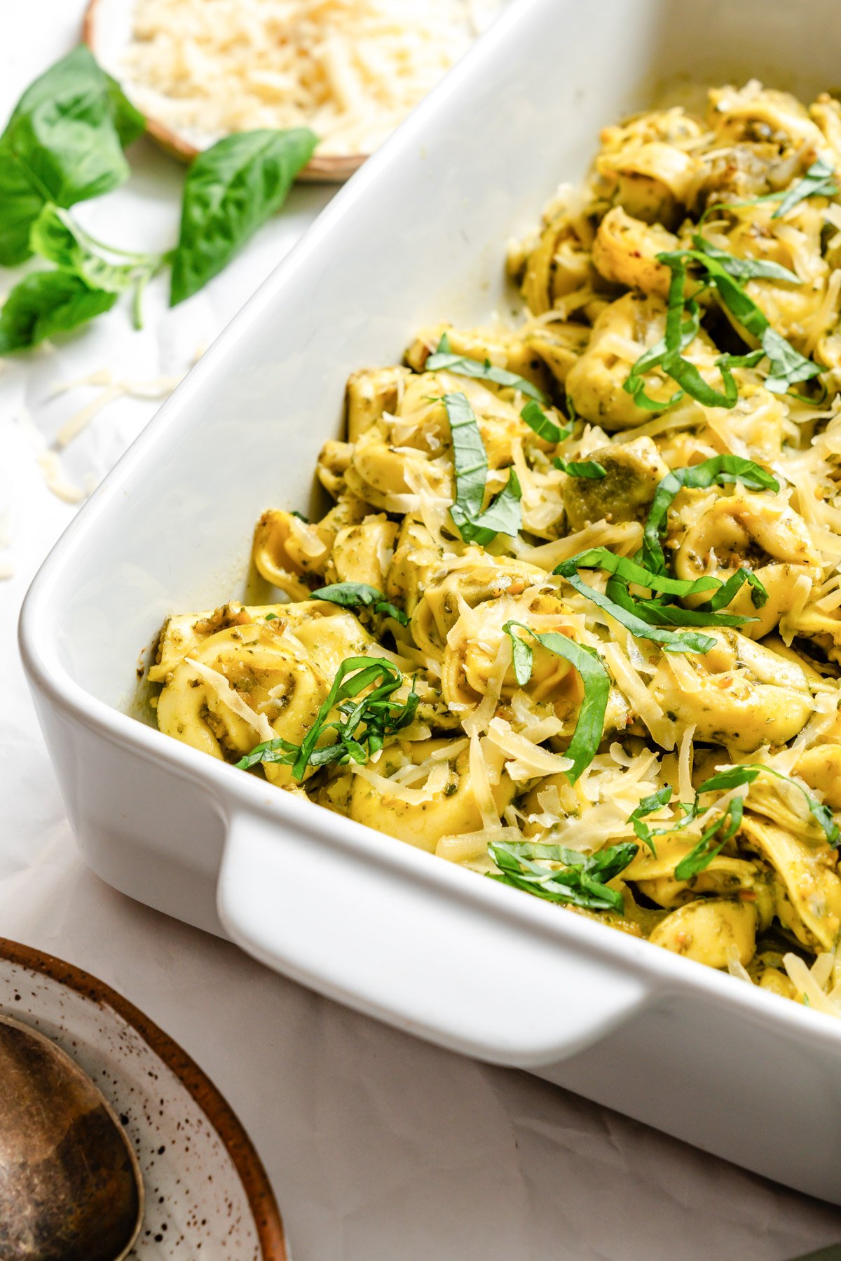 the finished dish topped with fresh basil and more parmesan cheese