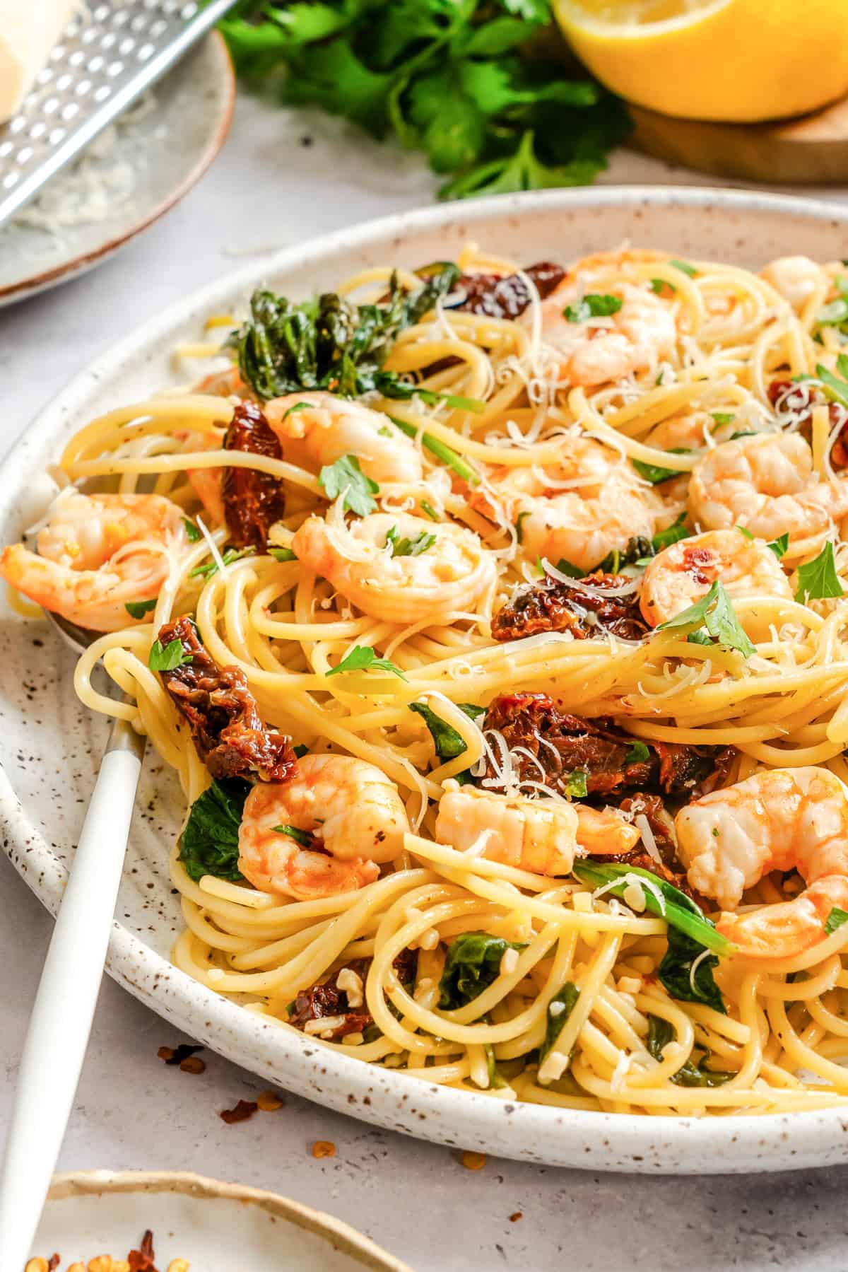 Simple Shrimp Scampi with Sun-dried tomatoes on a white plate