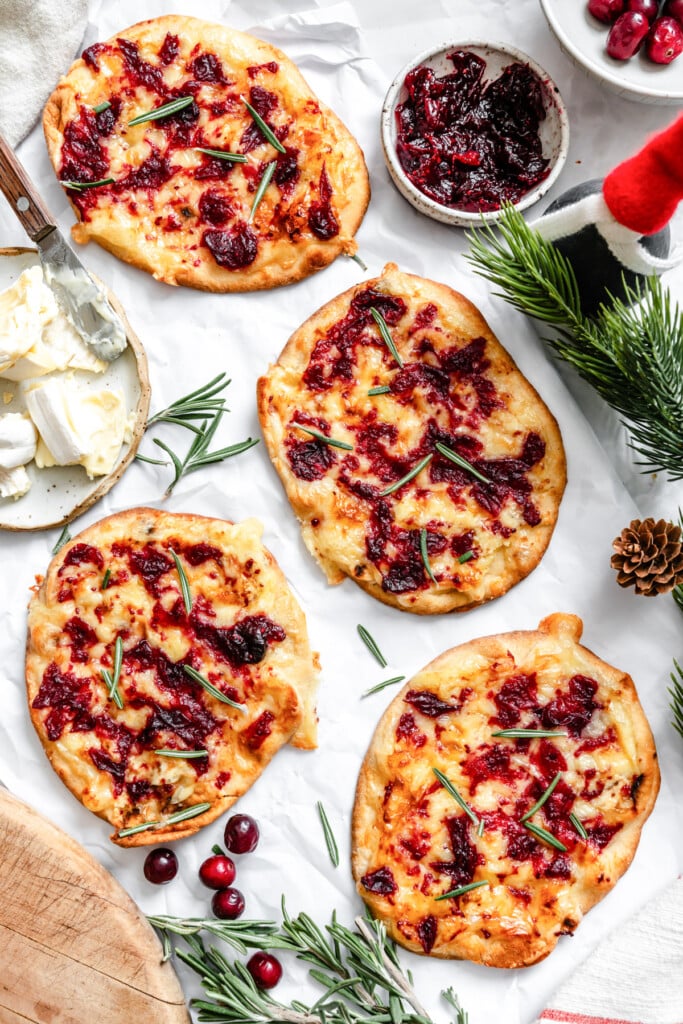 Warm Brie Cranberry Naan Bread on a white surface 