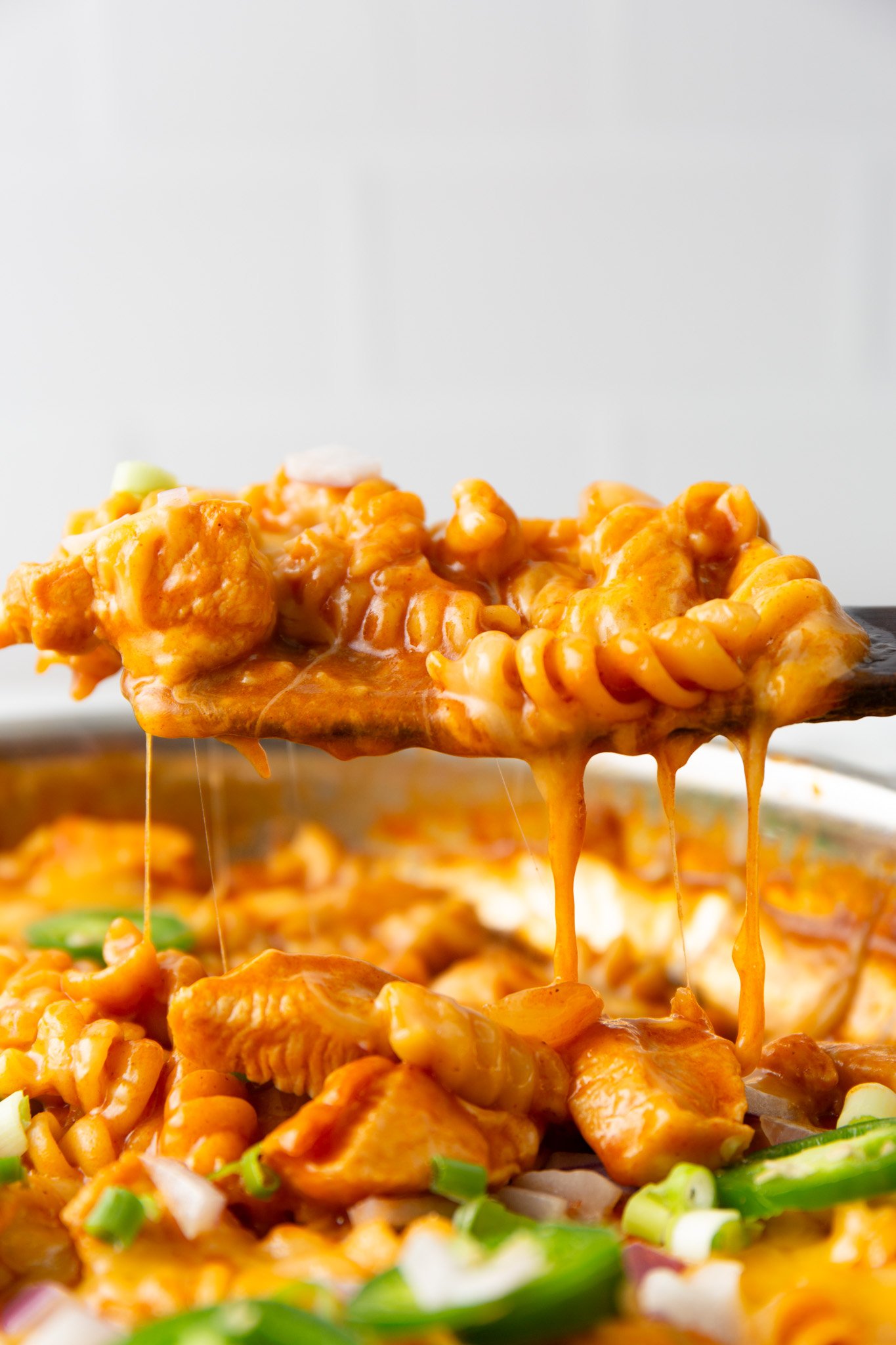 One Pot Chicken Enchilada Pasta on a wooden spoon 