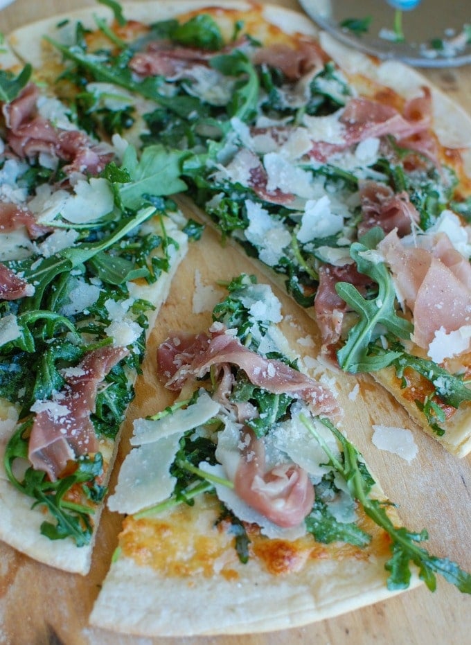 Prosciutto Arugula Pizza piece cut. 