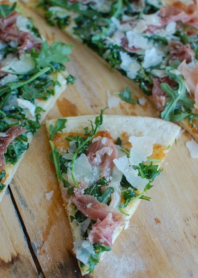 Prosciutto Arugula Pizza slice of pizza.
