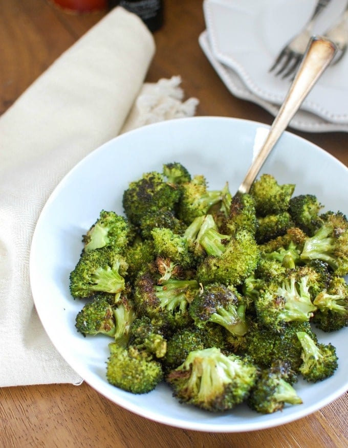 Roasted Broccoli in a bowl with a spoon.