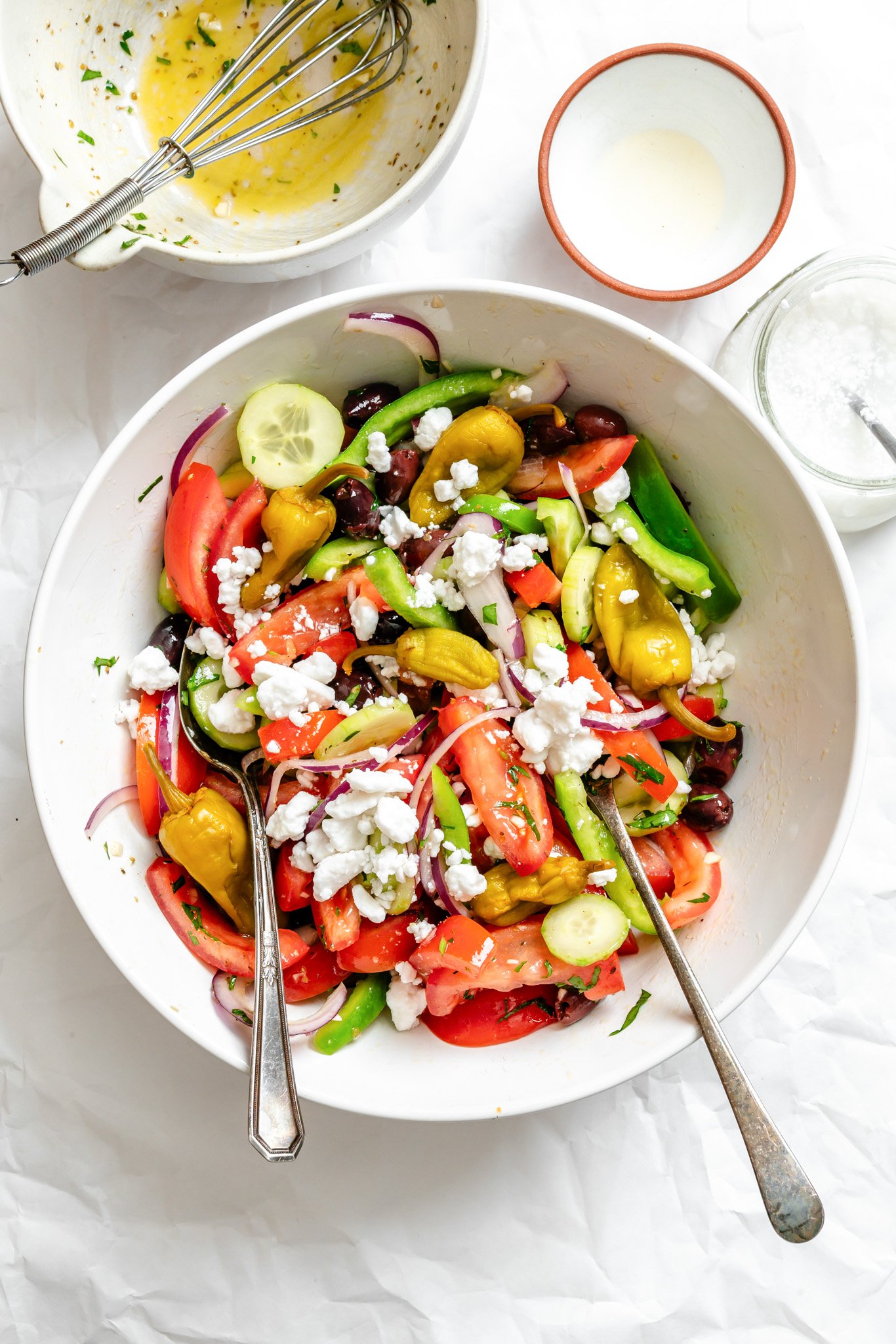 Greek Village Salad in a bowl with serving spoons