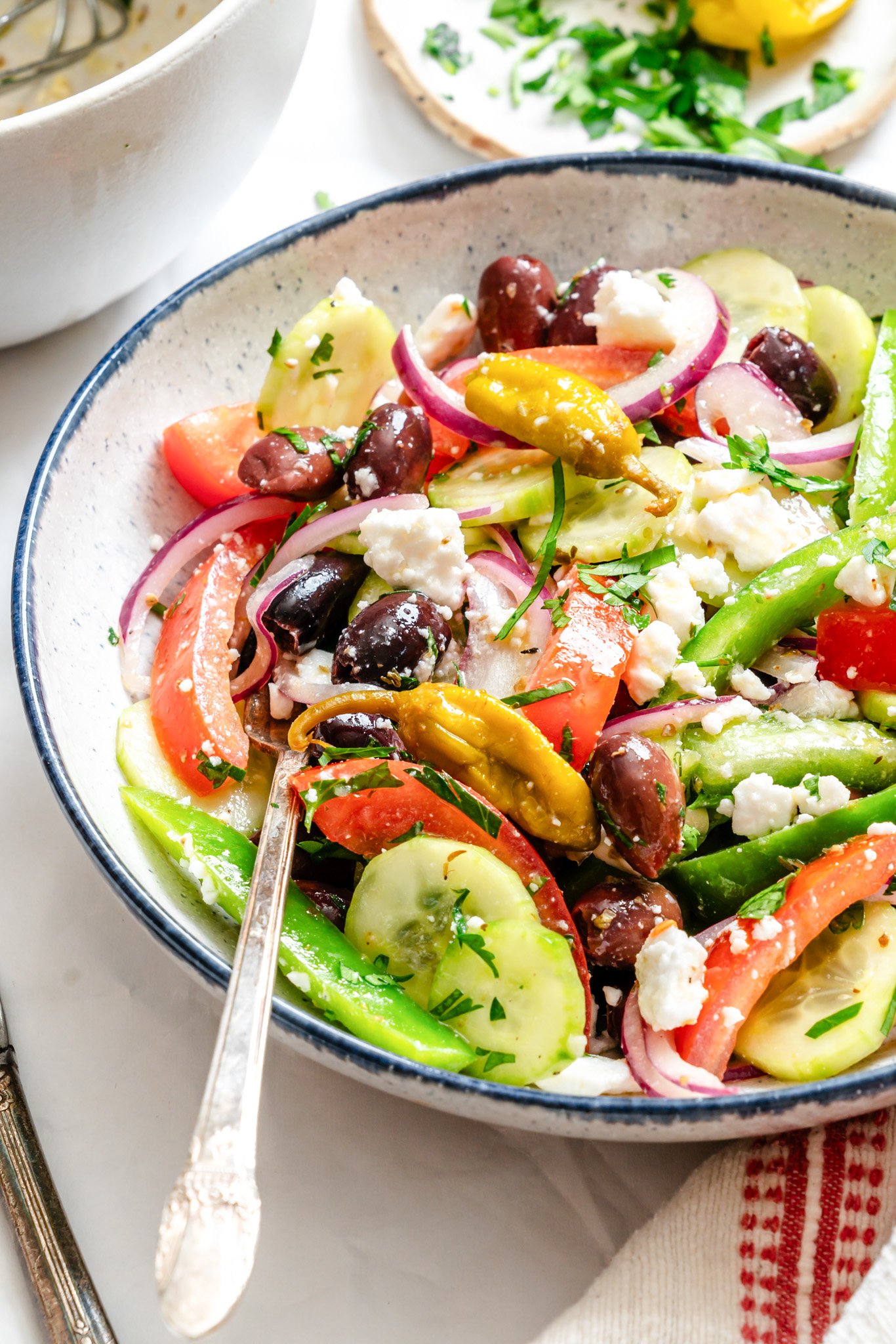 Greek village Salad in a white bowl with a fork