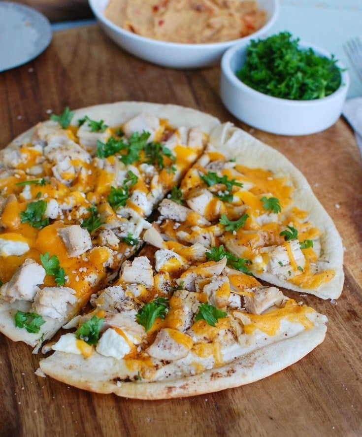 Chicken Feta Cheddar Pita Pitza on a cutting board. 