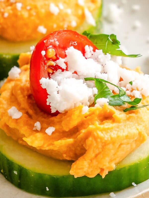 Cucumber Hummus Bite on a white plate with feta cheese