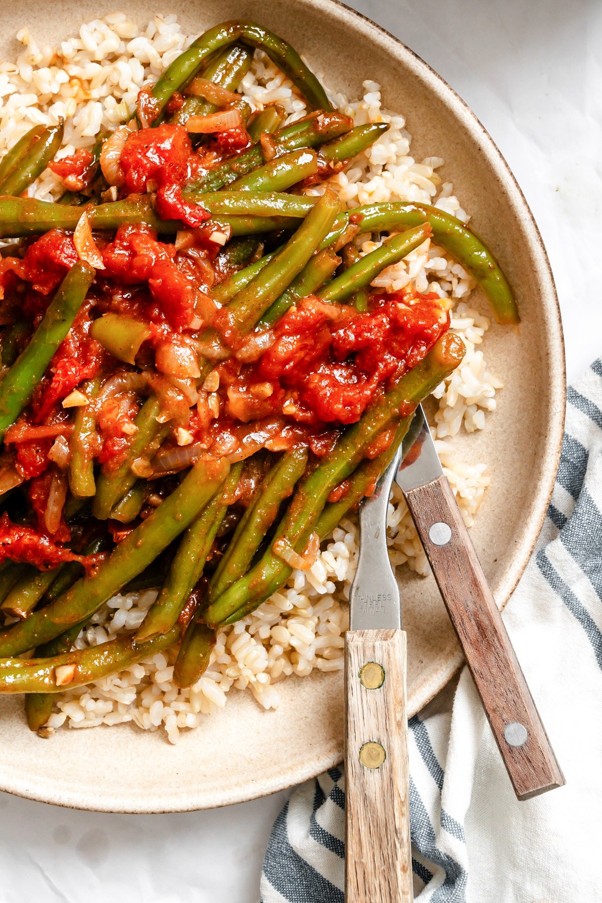Lebanese Green Beans in a bowl with fork and knife 