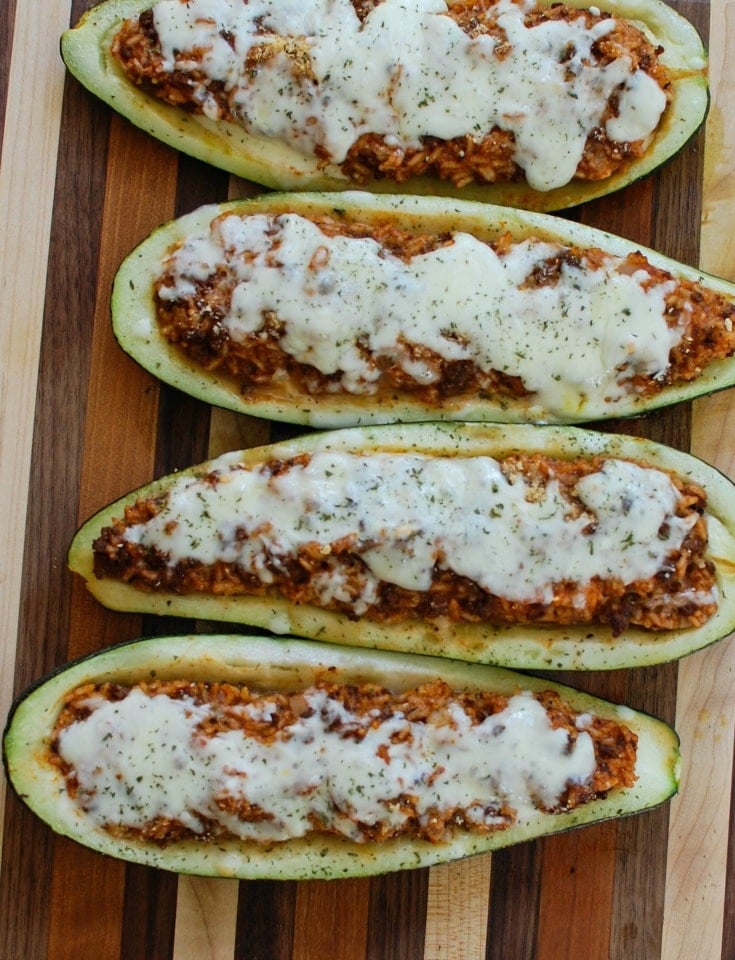Mediterranean Zucchini Boats take summer zucchini and stuff them with a mixture of ground beef and lamb, rice, tomato sauce, cumin, cinnamon and are topped with cheese and fresh parsley. If you have an abundance of garden zucchini this is the perfect way to use them up! 