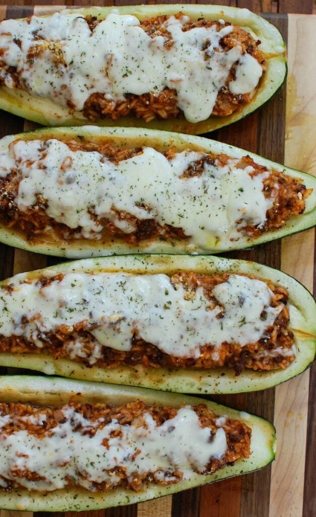 Mediterranean Zucchini Boats take summer zucchini and stuff them with a mixture of ground beef and lamb, rice, tomato sauce, cumin, cinnamon and are topped with cheese and fresh parsley. If you have an abundance of garden zucchini this is the perfect way to use them up! 