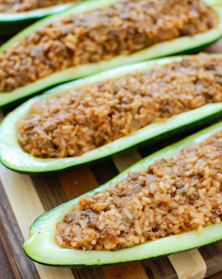 Mediterranean Zucchini Boats take summer zucchini and stuff them with a mixture of ground beef and lamb, rice, tomato sauce, cumin, cinnamon and are topped with cheese and fresh parsley. If you have an abundance of garden zucchini this is the perfect way to use them up! 