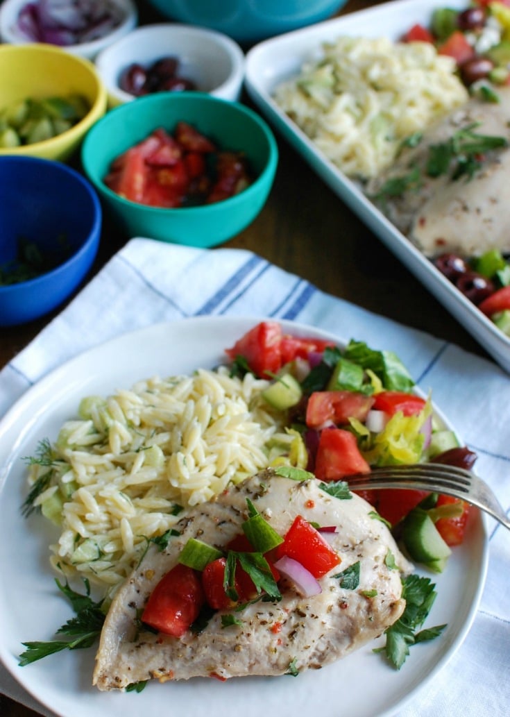Greek Chicken with Tzatziki Orzo Salad with fork.