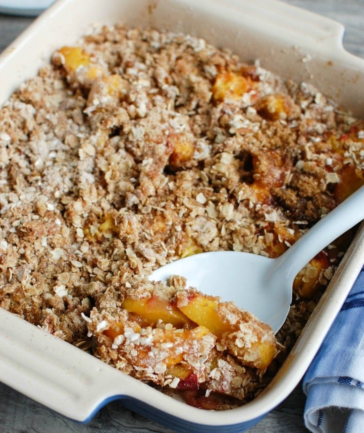 Peach Crisp is the best summer dessert. Fresh, warm peaches are topped with a crumbly topping and paired with ice cream. 