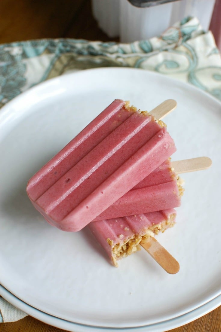 Strawberry Banana Yogurt Popsicles are the perfect warm weather, summer treat! These popsicles are healthy and taste like dessert. Fresh strawberries, bananas, Greek yogurt, milk and honey create a kid-friendly snack or dessert.