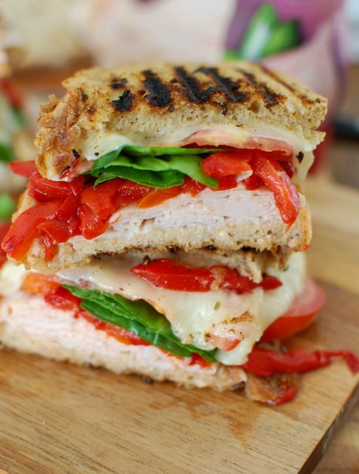 Mediterranean Turkey Hummus Panini makes a great lunch packing your favorite Mediterranean flavors into a warm, flavorful sandwich. Garlic and Herb hummus is spread on your favorite bread and topped with smoked turkey, roasted red peppers, spinach, sliced tomatoes, artichokes and havarti cheese to create the ultimate sandwich.