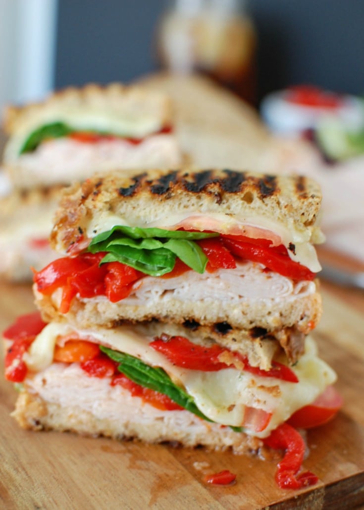 Mediterranean Turkey Hummus Panini makes a great lunch packing your favorite Mediterranean flavors into a warm, flavorful sandwich. Garlic and Herb hummus is spread on your favorite bread and topped with smoked turkey, roasted red peppers, spinach, sliced tomatoes, artichokes and havarti cheese to create the ultimate sandwich.