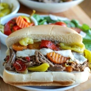 Slow Cooker Italian Beef Sandwiches on a white plate and on a bun