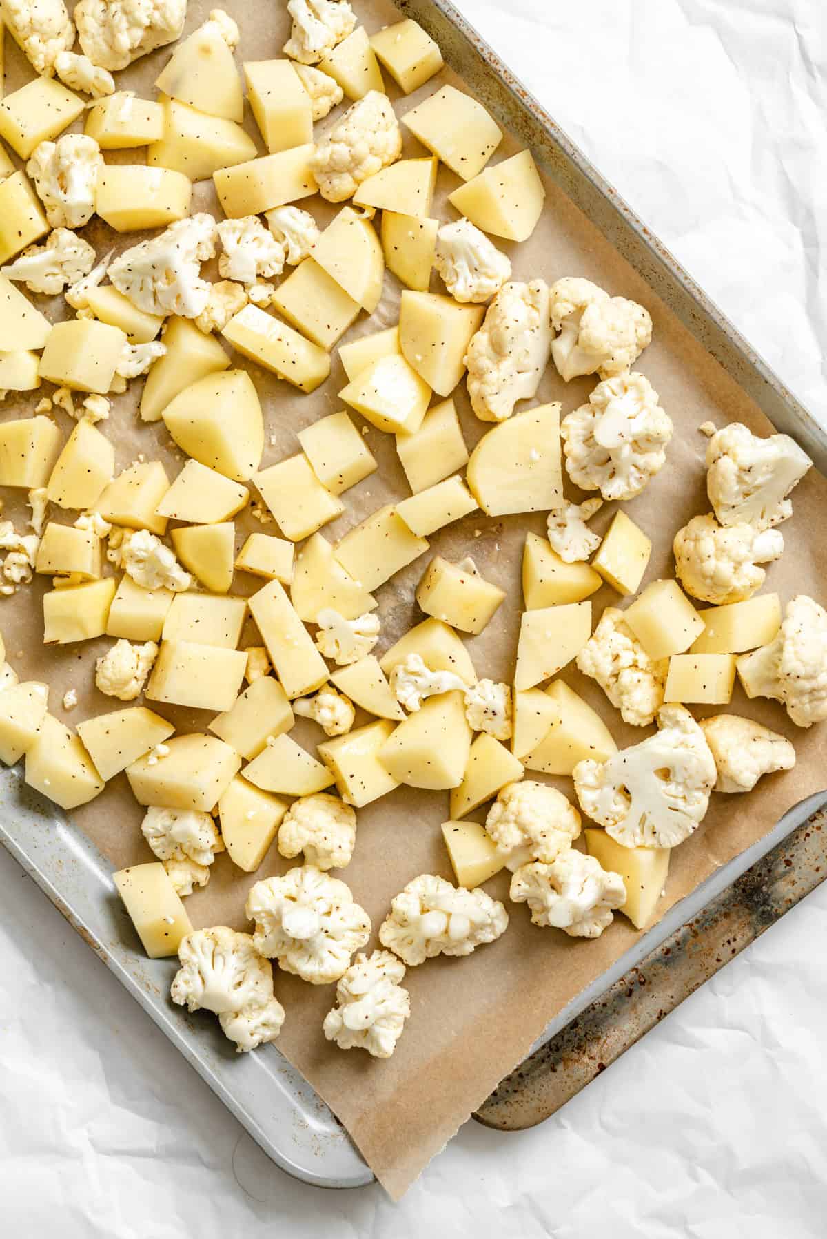 Cauliflower Potato Salad roasting on a baking sheet