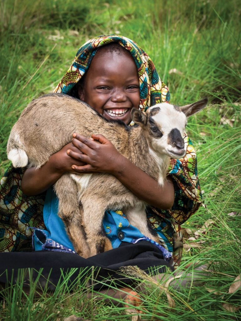Gasorwe, Burundi. Gift Catalog: Chanian Niyonyishu, girl child, 5-years-old, pictured with a baby goat. Quote from mother, Zuena Mukeshimana: "With the goat we received, we can now fertilize our ground for better food production."