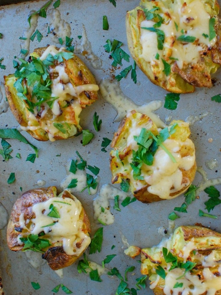 Golden potatoes are drizzled with olive oil and garlic and baked until crispy and then topped with gouda and warmed until the cheese is warm and melted. Gouda Smashed Potatoes are the perfect holiday side dish that will impress your guests.