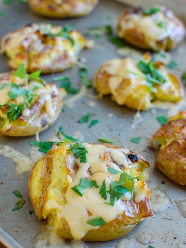 Golden potatoes are drizzled with olive oil and garlic and baked until crispy and then topped with gouda and warmed until the cheese is warm and melted. Gouda Smashed Potatoes are the perfect holiday side dish that will impress your guests.