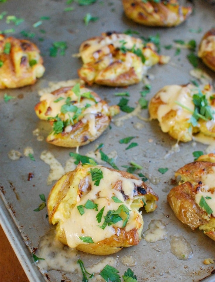 Golden potatoes are drizzled with olive oil and garlic and baked until crispy and then topped with gouda and warmed until the cheese is warm and melted. Gouda Smashed Potatoes are the perfect holiday side dish that will impress your guests. 