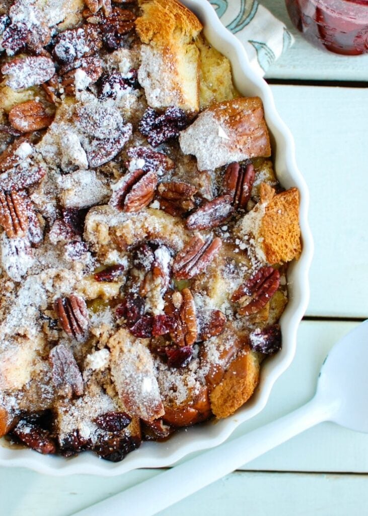 Overnight Eggnog French Toast Bake with Cranberry Maple Syrup in white pan