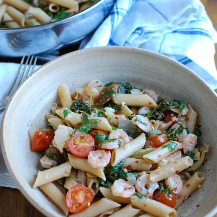 Shrimp Kale Artichoke Pasta is light, healthy and an easy meal idea. Shrimp, kale, artichokes, tomatoes and pasta and tossed in a light lemon sauce that will leave your family asking for seconds!