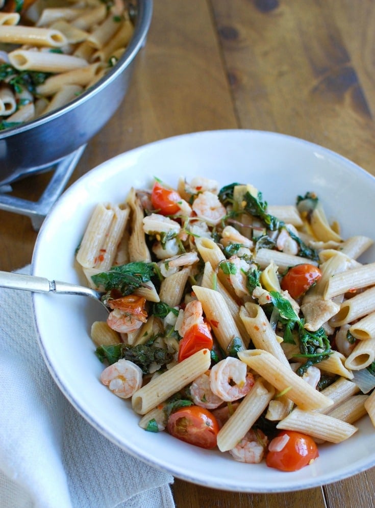 Shrimp Kale Artichoke Pasta is light, healthy and an easy meal idea. Shrimp, kale, artichokes, tomatoes and pasta and tossed in a light lemon sauce that will leave your family asking for seconds! 