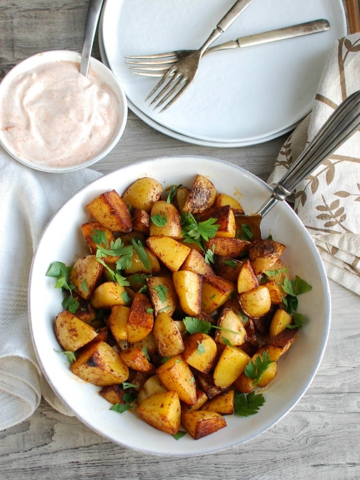 Your favorite potatoes are tossed in olive oil and smoked paprika and roasted until they are soft on the inside and crispy on the outside paired with a creamy yogurt dipping sauce. These Paprika Roasted Potatoes with Spiced Yogurt Sauce make the perfect side dish to any meal.