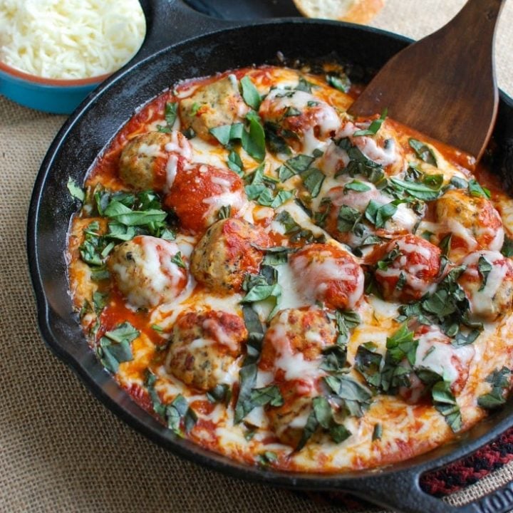 This Skillet Tomato Basil Meatballs is warm, cheesy and the perfect appetizer for a party, game day or for your family to enjoy. Tomato basil meatballs are cooked in a rich tomato sauce and topped with gooey, warm cheese and fresh basil. Pair it with warm baguette to create the perfect bite sized appetizer!