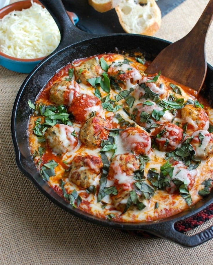 This Skillet Tomato Basil Meatballs is warm, cheesy and the perfect appetizer for a party, game day or for your family to enjoy. Tomato basil meatballs are cooked in a rich tomato sauce and topped with gooey, warm cheese and fresh basil. Pair it with warm baguette to create the perfect bite sized appetizer!