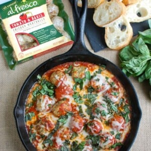 This Skillet Tomato Basil Meatballs is warm, cheesy and the perfect appetizer for a party, game day or for your family to enjoy. Tomato basil meatballs are cooked in a rich tomato sauce and topped with gooey, warm cheese and fresh basil. Pair it with warm baguette to create the perfect bite sized appetizer!