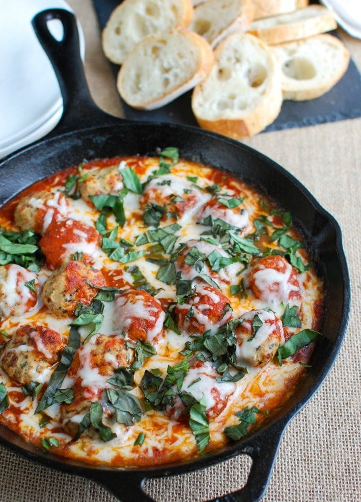 This Skillet Tomato Basil Meatballs is warm, cheesy and the perfect appetizer for a party, game day or for your family to enjoy. Tomato basil meatballs are cooked in a rich tomato sauce and topped with gooey, warm cheese and fresh basil. Pair it with warm baguette to create the perfect bite sized appetizer! 