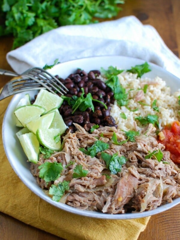 Slow Cooker Cuban Pork Rice Bowls make a healthy lunch or dinner that are easily customizable to your tastes. Cook the pork in the slow cooker with orange juice, lime and garlic along with rich spices to create a juicy, flavorful pulled pork. Pair the pork with rice and throw on your favorite toppings for an easy on-the-go lunch!