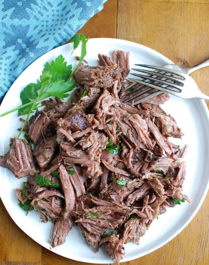 Slow Cooker Red Wine Short Ribs are fall off the bone tender, juicy and full of flavor. These short ribs make the perfect romantic dinner paired with your favorite mashed potatoes and fresh vegetables. The shredded short rib meat also works great in tacos, burrito bowls or in pasta sauces. 