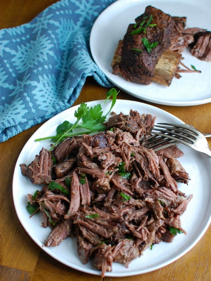 Slow Cooker Red Wine Short Ribs are fall off the bone tender, juicy and full of flavor. These short ribs make the perfect romantic dinner paired with your favorite mashed potatoes and fresh vegetables. The shredded short rib meat also works great in tacos, burrito bowls or in pasta sauces. 