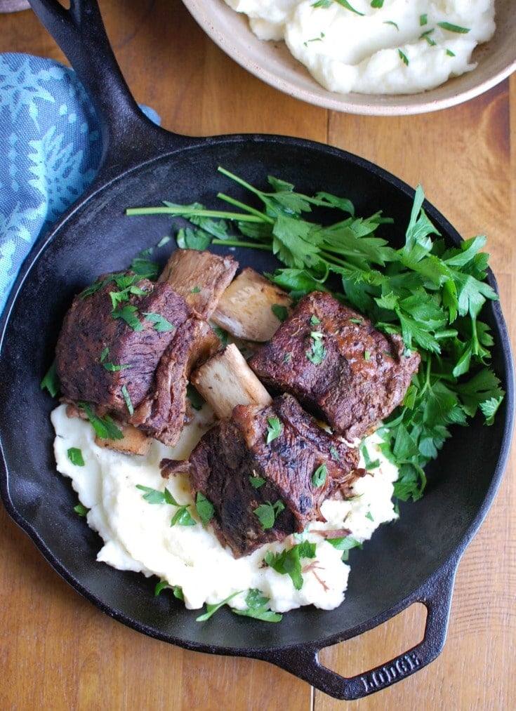Slow Cooker Red Wine Short Ribs are fall off the bone tender, juicy and full of flavor. These short ribs make the perfect romantic dinner paired with your favorite mashed potatoes and fresh vegetables. The shredded short rib meat also works great in tacos, burrito bowls or in pasta sauces. 