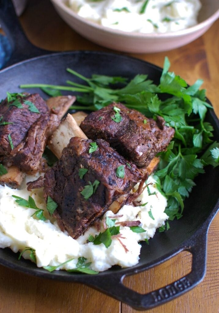 Slow Cooker Red Wine Short Ribs are fall off the bone tender, juicy and full of flavor. These short ribs make the perfect romantic dinner paired with your favorite mashed potatoes and fresh vegetables. The shredded short rib meat also works great in tacos, burrito bowls or in pasta sauces. 